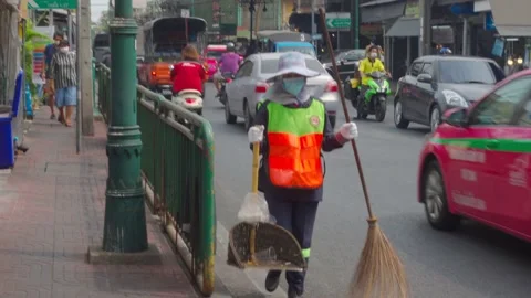 Asian Road Sweeper Worker is working on the street - Bangkok, Thailand Stock Footage 147617791