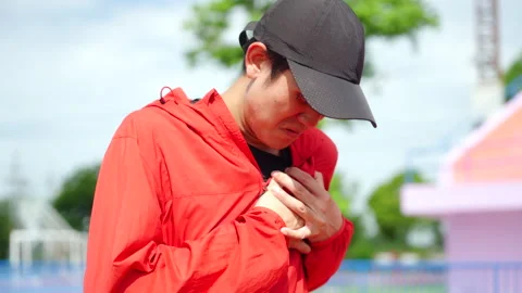 Asian runner man having heart attack or chest pain after running workout. Stock Footage 248123705