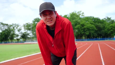 Asian runner man having heart attack or chest pain after running workout. Video stock 248768382