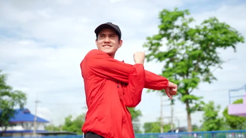 Asian runner man stretching his body warm up before workout. Stock Footage 248768341