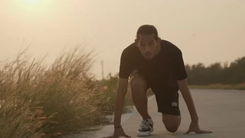 Asian runner start and runs on street in countryside with fresh and clear air Stock Footage 150365732