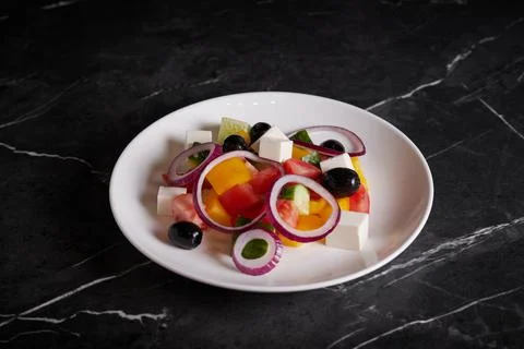 Asian salad with meat and seafood, shrimp, plate close-up on a dark background Stock Photos