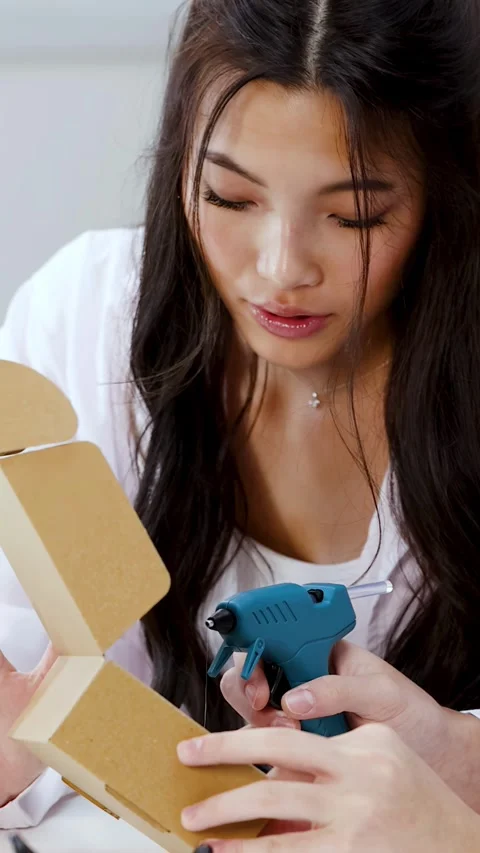 Asian Science Students Using Hot Glue Gun on Engineering Project Stock Footage 341662398