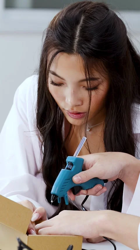 Asian Science Students Using Hot Glue Gun for Engineering Project Stock Footage 341662641