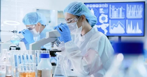 Asian scientist use microscope Stock Footage 117383704