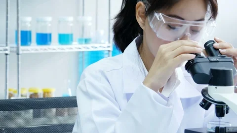 Asian Scientist use microscope for work at laboratory. 스톡 동영상 93034692