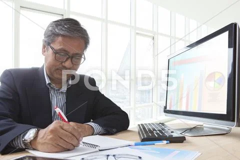 Asian senior business man working on computer table for office life theme Stock Photos
