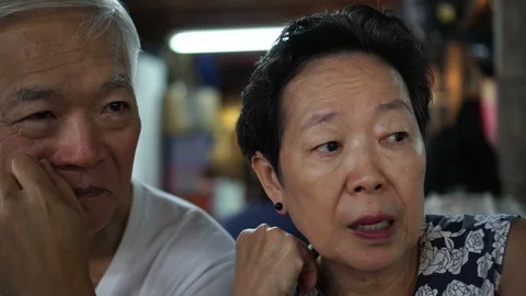 Asian senior couple talking date in local restaurant Stock Footage