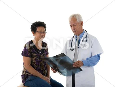 Asian senior doctors and patient performing medical checkup Stock Photos