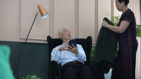 Asian senior elder coupld taking care of each other bringing jacket showing l Stock Footage 141785754