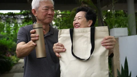 Asian senior elder couple using reusable bag and cup go green to use less pla Stock Footage 140036612