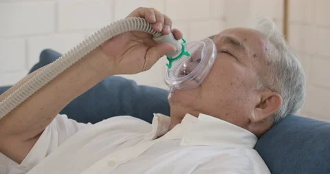 Asian senior elderly man does medical therapy steam inhalation at home. Stock Footage 153249873
