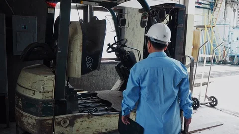 An asian senior engineer checking on a forklift Video stock 116751055