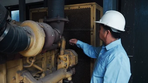 An asian senior engineer checking on industrial power generator Video stock 116750958