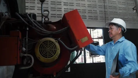 An asian senior engineer using industrial machine controller Stock Footage 116751227