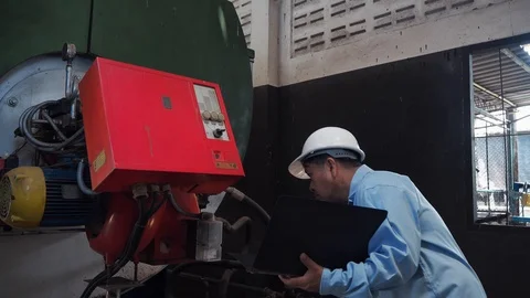 An asian senior engineerchecking on industrial machine controller Video stock 116751132