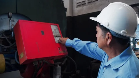 An asian senior engineerusing industrial machine controller Stock Footage 116751069