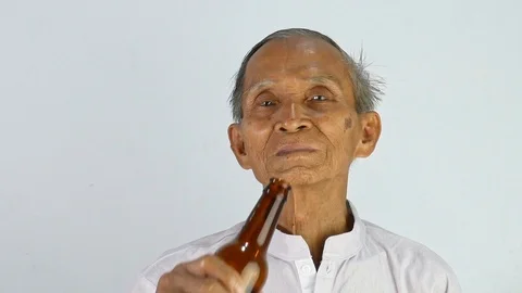 Asian senior man drinking some alcohol. Dangerous lifestyle warning concept. Stock Footage 114554199