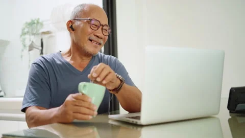 Asian Senior man using laptop Stock Footage 200699849