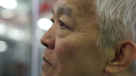 Asian senior man with worry expression in eyes close up talking Stock-Footage 137598142