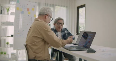 Asian Senior Men Developers Collaborate on Software Project in Home Office. Stock Footage 308156863