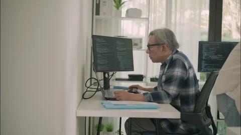Asian Senior Programmer Working Focused In A Quiet Modern Tech Workspace. Stock Footage 308163763