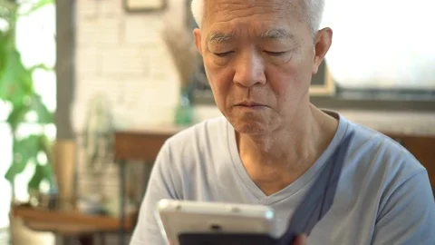 Asian senior smile after using tablet Stock Footage 113671496