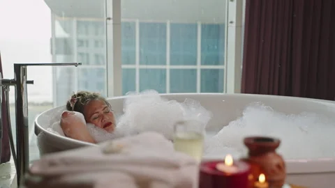 young woman relaxing and takes bubble bath in bathtub with foam, People  Stock Footage ft. woman & bath - Envato Elements