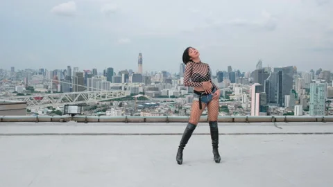 Asian sexy woman perform dance on terrace or rooftop of high building Stock Footage 155530162