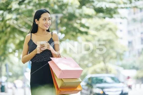 Asian shopaholic in big city Stock Photos