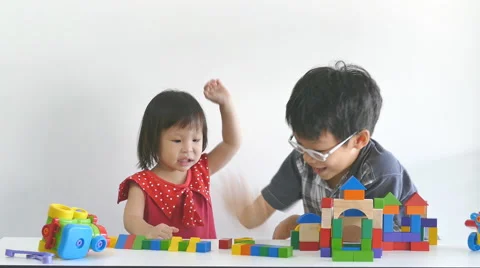 Asian siblings playing blocks Stock Footage 56349247