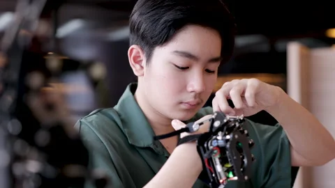 Asian smart boy focus on robotic arm innovative technology developed to hel.. Stock Footage 245069806