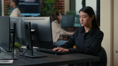 Asian software developer focused on writing code encounters unexpected compiling Stock Footage 168236834
