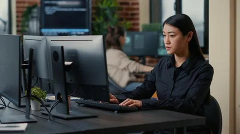 Asian software developer focused on writing code encounters unexpected compiling Stock Photos