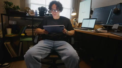 Asian Software Developer Testing App on Tablet in Home Office Stock Footage 338424478