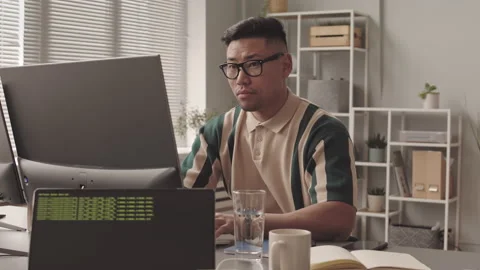 Asian Software Developer Typing on Computer Stock Footage 195980401