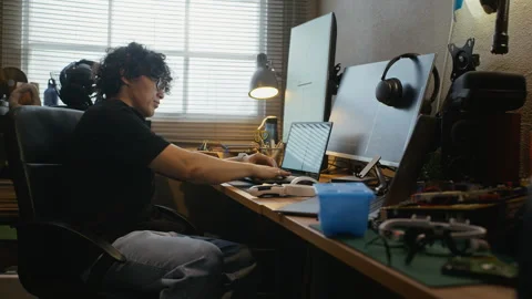 Asian Software Developer Typing on Laptop at Home Office Desk Stock Footage 338424476
