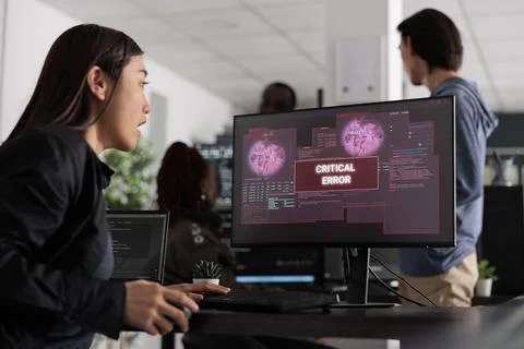 Asian software developer writing html code encountering hacking alert on 스톡 사진