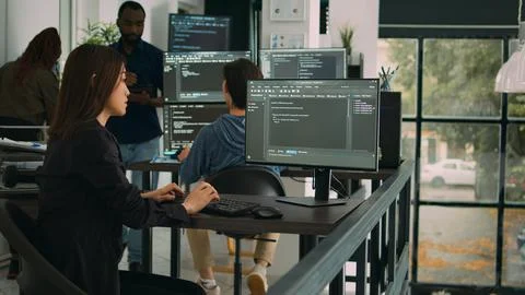 Asian software engineer working with user interface on computer screen Stock Photos
