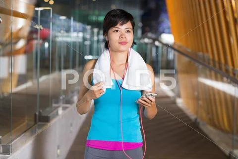 Asian Sportswoman Listening to Music in Gym Hall Stock Photos