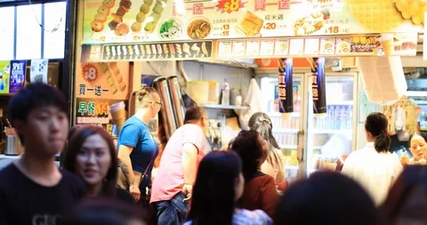 Asian street food in Hong Kong city life background. Crowds of people walk Stock Footage