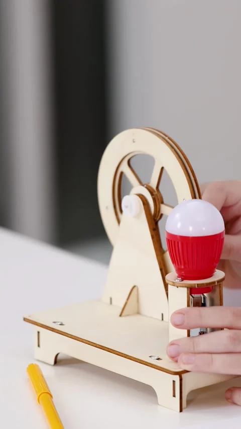 Asian Student Assembling Wooden Electricity Generator Model in Science Classroom Stock Footage 340373586