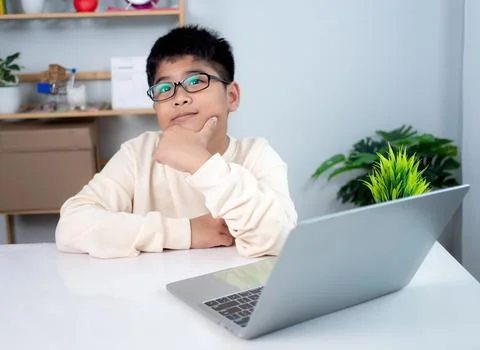 Asian student boy thinking using computer learning. Educational of tech con.. Stock Photos