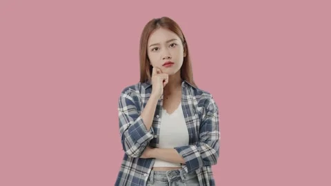 Asian student with doubtful face thinking on pink background. Stock Footage 220896581