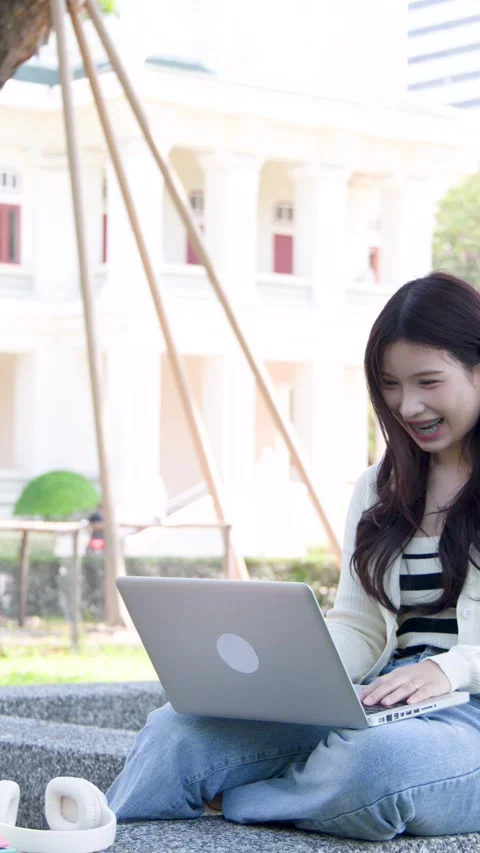 Asian Student Having a Video Call on Laptop at University Campus Stock Footage 336352138