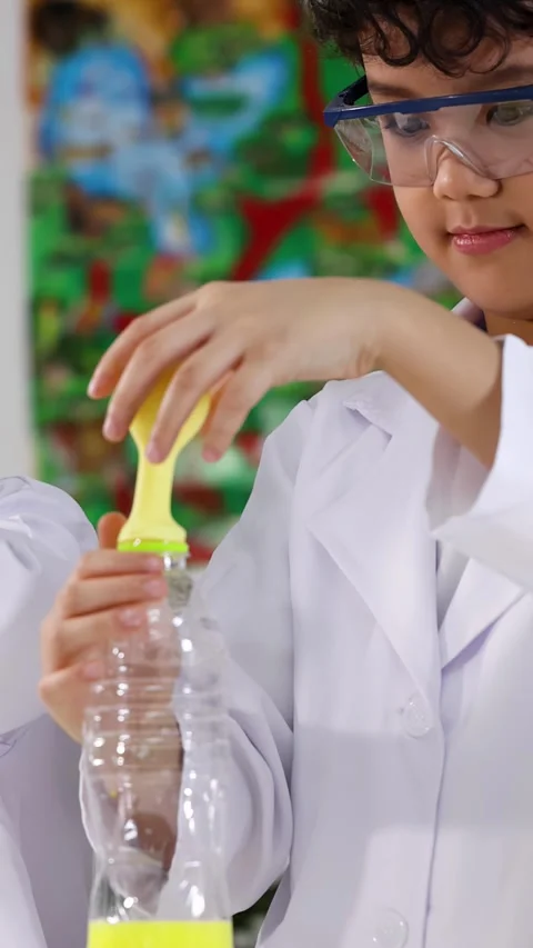 Asian Student in Lab Coat Performing Chemical Reaction Science Experiment Video stock 338155001