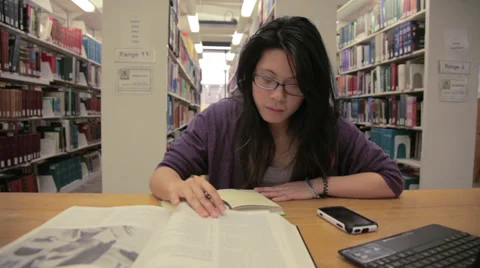 Asian Student in library Studying Dolly shot Stock Footage 27367823