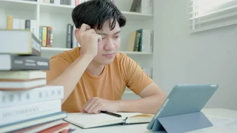 Asian student man research sample exam by tablet, male prepare for test and.. Stock Footage 233871807