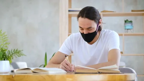 Asian student in protective mask studying at home Stock Footage 151832839