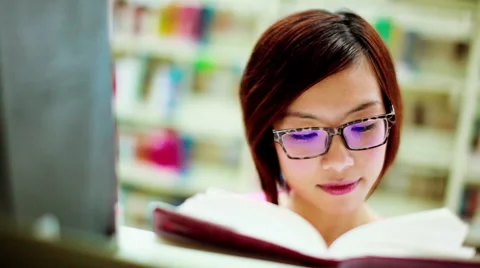 Asian student reading book (after color correction) Stock Footage 46971494